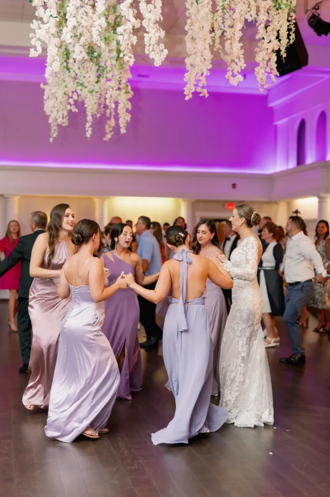 Bride and bridesmaids dancing on the dance floor at a wedding in Croatian Lodge