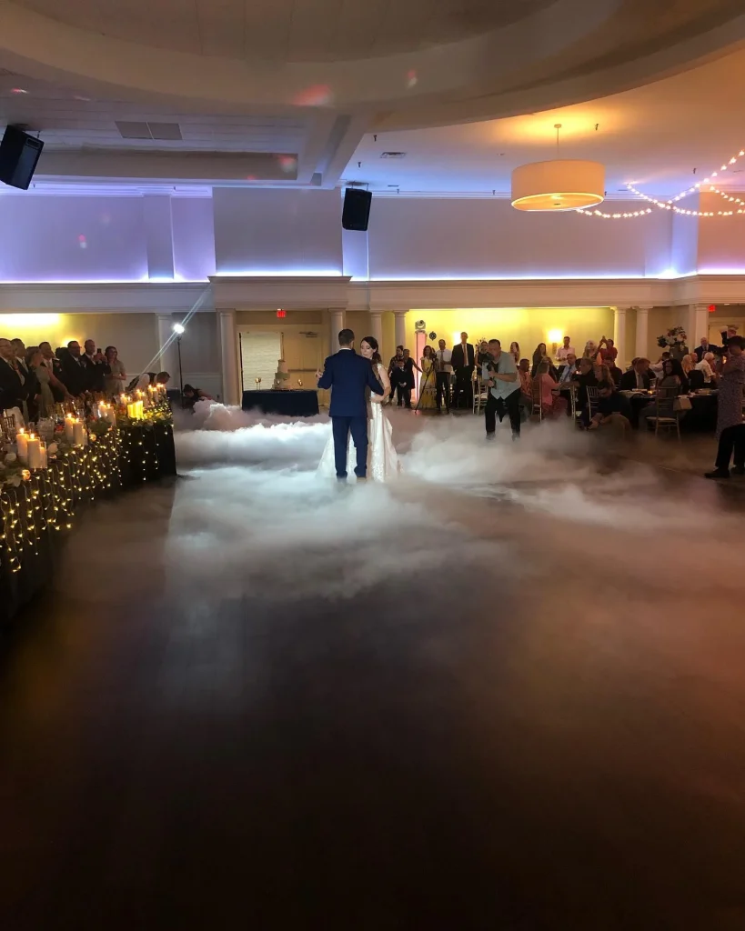 First dance of the newlyweds with fog covering the floor beneath them at Croatian Lodge